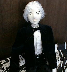 Doll in black suit